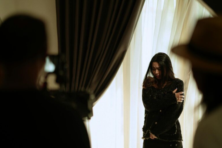 A woman actor performing a scene indoors, captured with dramatic lighting and intense emotion.